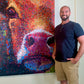 Brandon Bouck artist with a painting of a cow